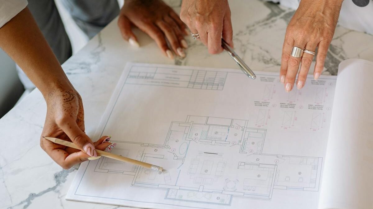 Women collaborating on architectural plans, emphasizing teamwork and precision.